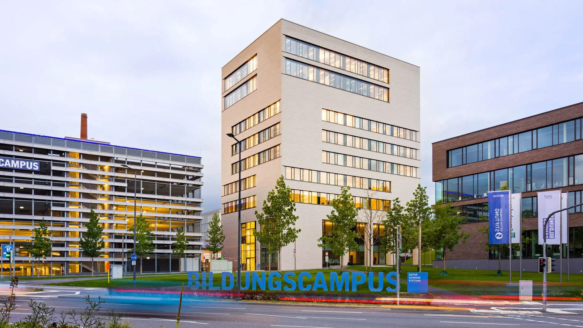 TUM tower with a street and the Bildungscampus sign in the foreground
