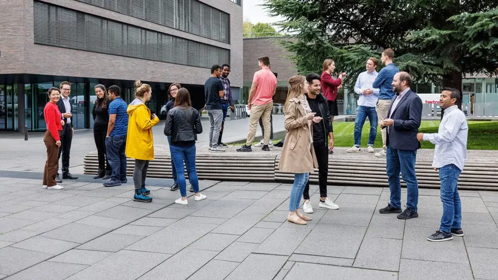 International students talking in outdoor area.